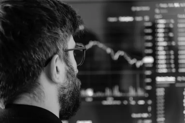 An asset manager looking intently at a financial data screen.